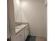 Bathroom featuring double sinks with granite countertops and white cabinets providing a clean and modern look at 2722 Numa Falls Ave, Davenport, FL 33837