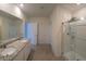 Bright bathroom featuring double sinks, granite counters, and glass-enclosed shower at 2722 Numa Falls Ave, Davenport, FL 33837