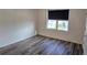 A bright bedroom features wood floors and a window at 2722 Numa Falls Ave, Davenport, FL 33837