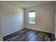 Bedroom with wood-look flooring, neutral walls and a window at 2722 Numa Falls Ave, Davenport, FL 33837