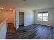 Bright bedroom with wood-style floors, large window, and open closet offer plenty of storage space at 2722 Numa Falls Ave, Davenport, FL 33837