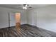 Large bedroom featuring a ceiling fan, wood-look flooring, and a double-door closet at 2722 Numa Falls Ave, Davenport, FL 33837