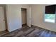 Bedroom with wood-style floors, featuring a window and an open closet, providing ample storage and light at 2722 Numa Falls Ave, Davenport, FL 33837