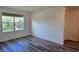 Bedroom with wood-look flooring, neutral walls and a window at 2722 Numa Falls Ave, Davenport, FL 33837