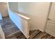 Spacious upstairs hallway featuring wood-look flooring and a crisp, neutral palette at 2722 Numa Falls Ave, Davenport, FL 33837