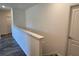 Bright upstairs hallway with stylish wood-look flooring and white doors at 2722 Numa Falls Ave, Davenport, FL 33837