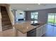 Open-concept kitchen featuring granite countertops, stainless steel appliances, and a cozy breakfast bar at 2722 Numa Falls Ave, Davenport, FL 33837