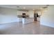 Open-concept kitchen with granite countertops, stainless steel appliances and large kitchen island at 2722 Numa Falls Ave, Davenport, FL 33837