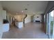 Open-concept living area featuring tile floors and neutral paint, seamlessly flowing into the kitchen at 2722 Numa Falls Ave, Davenport, FL 33837