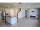 Spacious living area with modern kitchen and cozy fireplace feature wall at 2722 Numa Falls Ave, Davenport, FL 33837