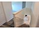 Staircase with wood steps, white banister, and view of the kitchen with granite island at 2722 Numa Falls Ave, Davenport, FL 33837