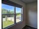 A window overlooks a serene fenced backyard, offering a private outdoor view from the home at 2722 Numa Falls Ave, Davenport, FL 33837