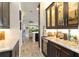 Convenient bar area with granite countertops, wine fridge, and glass-front cabinets for elegant display at 2736 Southland St, St Cloud, FL 34772