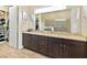 Spacious bathroom with dual sinks, a large mirror, walk-in closet, and luxurious shower at 2736 Southland St, St Cloud, FL 34772