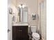 Clean bathroom featuring a granite vanity, brushed metal fixtures, patterned shower curtain and neutral paint at 2736 Southland St, St Cloud, FL 34772