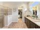 Modern bathroom with a walk-in shower, dual vanities, granite countertops, and a walk-in closet at 2736 Southland St, St Cloud, FL 34772