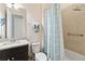 Well lit bathroom featuring a granite vanity, brushed metal fixtures, patterned shower curtain and neutral paint at 2736 Southland St, St Cloud, FL 34772
