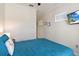 Calm bedroom featuring a ceiling fan, plush blue bedding, wood-look flooring, and wall mounted tv at 2736 Southland St, St Cloud, FL 34772