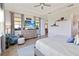Serene bedroom with a ceiling fan, a comfortable bed, and a view of the lanai from the windows at 2736 Southland St, St Cloud, FL 34772