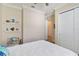Bright bedroom featuring shelving for decor and a closet with classic white door at 2736 Southland St, St Cloud, FL 34772