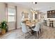Bright dining room with a large window and an open view of the kitchen at 2736 Southland St, St Cloud, FL 34772