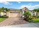Beautiful single Gathering home with lush landscaping, a brick driveway, and an American flag displayed at 2736 Southland St, St Cloud, FL 34772