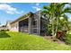 Rear exterior view showcasing the screened patio, lush landscaping, and private yard at 2736 Southland St, St Cloud, FL 34772