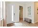 Bright foyer with wood-look tile flooring, a bench, and an open doorway at 2736 Southland St, St Cloud, FL 34772