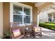 Cozy front porch featuring rocking chairs, vibrant flowers, and an American flag at 2736 Southland St, St Cloud, FL 34772
