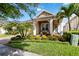 Inviting front porch with colorful landscaping, rocking chairs, and an American flag displayed at 2736 Southland St, St Cloud, FL 34772
