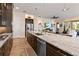 Modern kitchen with a large island, stainless steel appliances, and dark wood cabinetry at 2736 Southland St, St Cloud, FL 34772