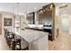 Modern kitchen island with bar stools, stainless steel appliances, and tile backsplash at 2736 Southland St, St Cloud, FL 34772