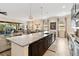 Modern kitchen with a large island and an open concept design that flows into the dining and living areas at 2736 Southland St, St Cloud, FL 34772