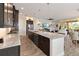 Gourmet kitchen with granite countertops, stainless steel appliances, and a large island overlooking the living spaces at 2736 Southland St, St Cloud, FL 34772