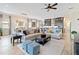Spacious living room featuring stylish furniture and an open floor plan with access to the kitchen and dining area at 2736 Southland St, St Cloud, FL 34772