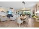 Open-concept living and dining area with a view of the lanai and outdoor seating at 2736 Southland St, St Cloud, FL 34772