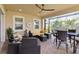 Comfortable screened-in patio with ceiling fan and ample seating for guests at 2736 Southland St, St Cloud, FL 34772