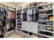 Spacious walk-in closet with custom shelving, drawers, and ample hanging space for optimal storage and organization at 2736 Southland St, St Cloud, FL 34772