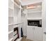Modern walk-in closet with white shelving and storage system, providing plenty of space for clothes and accessories at 2736 Southland St, St Cloud, FL 34772