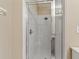 Clean bathroom showing a glass-door shower with chrome hardware and white tile at 2832 Osprey Cove Pl # 102, Kissimmee, FL 34746