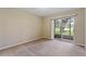 Neutral bedroom with a sliding glass door leading to a screened porch and views of the manicured lawn at 2832 Osprey Cove Pl # 102, Kissimmee, FL 34746