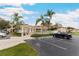 Exterior view of residential buildings, showcasing the community's well-maintained landscape and parking at 2832 Osprey Cove Pl # 102, Kissimmee, FL 34746
