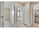 Hallway with a view into a bedroom and a bathroom with a granite vanity at 2832 Osprey Cove Pl # 102, Kissimmee, FL 34746