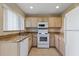 Kitchen with granite countertops, white appliances and tile flooring at 2832 Osprey Cove Pl # 102, Kissimmee, FL 34746