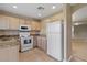 Kitchen featuring granite countertops, white appliances and tile flooring at 2832 Osprey Cove Pl # 102, Kissimmee, FL 34746
