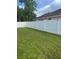 Large backyard with a white fence at 306 Clermont Dr, Kissimmee, FL 34759