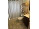 Bathroom featuring a tub with curtain, toilet, vanity, and a shelf at 306 Clermont Dr, Kissimmee, FL 34759