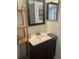 Bathroom featuring a vanity with sink, two mirrors, and a corner shelf at 306 Clermont Dr, Kissimmee, FL 34759