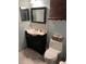 Bathroom features a vanity with drawers, a toilet, and a large mirror at 306 Clermont Dr, Kissimmee, FL 34759