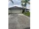 Home exterior featuring a two-car garage and neutral paint scheme at 306 Clermont Dr, Kissimmee, FL 34759